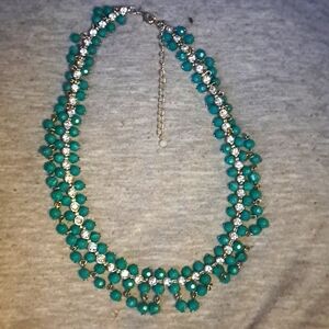 Green necklace with silver stones in the middle